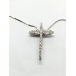 An 18ct white gold cross set with diamonds on a ch