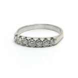 An 18ct white gold and seven stone diamond ring, a