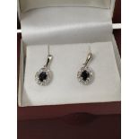 A pair of white gold drop earrings with central sa