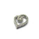 A white gold heart shaped pendant set with diamond