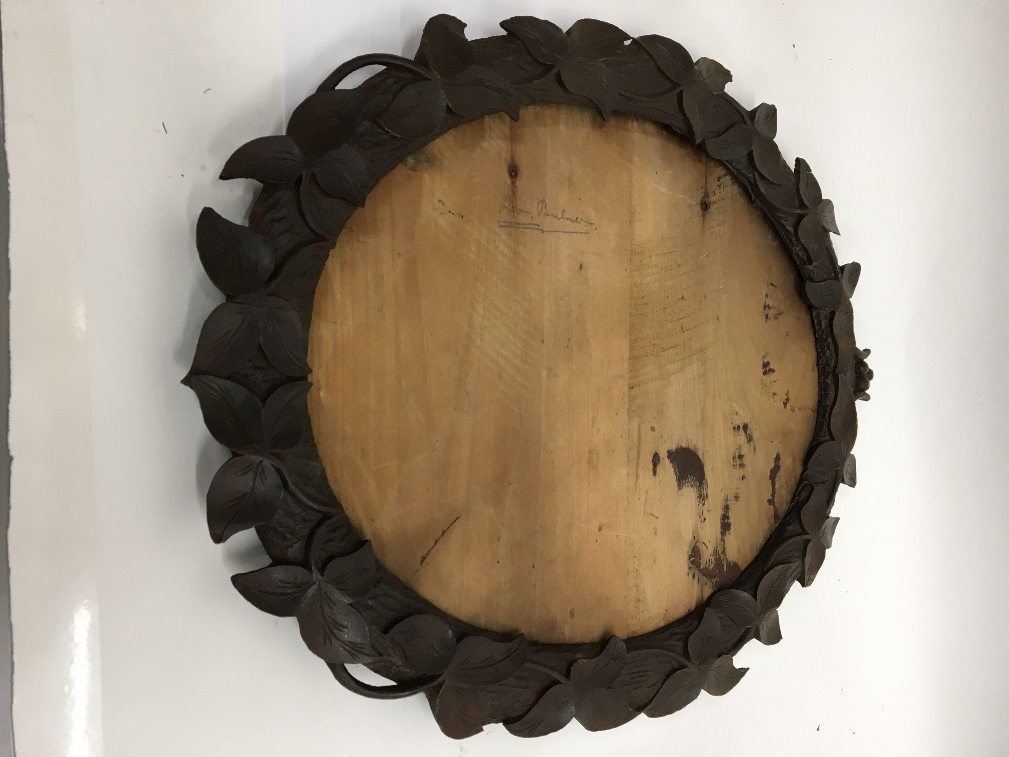 A Black Forest oval frame carved with foliage deco