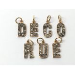 Seven gold letter pendants set with diamonds, appr