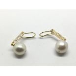 A pair of gold, possibly 18ct, diamond and pearl e