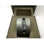 A boxed ladies Gucci bangle watch.