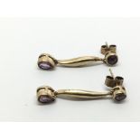 A pair of 9ct gold earrings set with amethyst, app