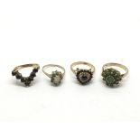 Four gold rings inset with garnet and emerald, app