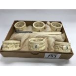 6 carved Chinese ivory napkin rings plus a silver