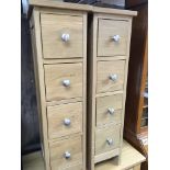 A pair of modern oak flights of drawers each with