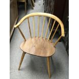 A single Ercol elm and beechwood arm chair.