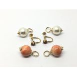 A pair of large coral earrings, a pair of garnet e