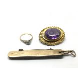 A 9ct gold penknife, an amethyst type brooch and a