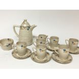 A Clarice Cliff coffee set hand painted with small