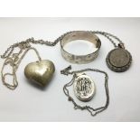 Three silver lockets, one in the shape of a heart