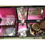 A musical jewellery box containing various ear stu