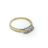 An 18carat gold ring set with three diamonds. ring