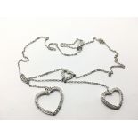 A 9ct white gold chain with three heart pendant se