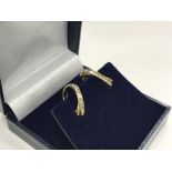 A pair of 9ct gold clip earrings set with baguette