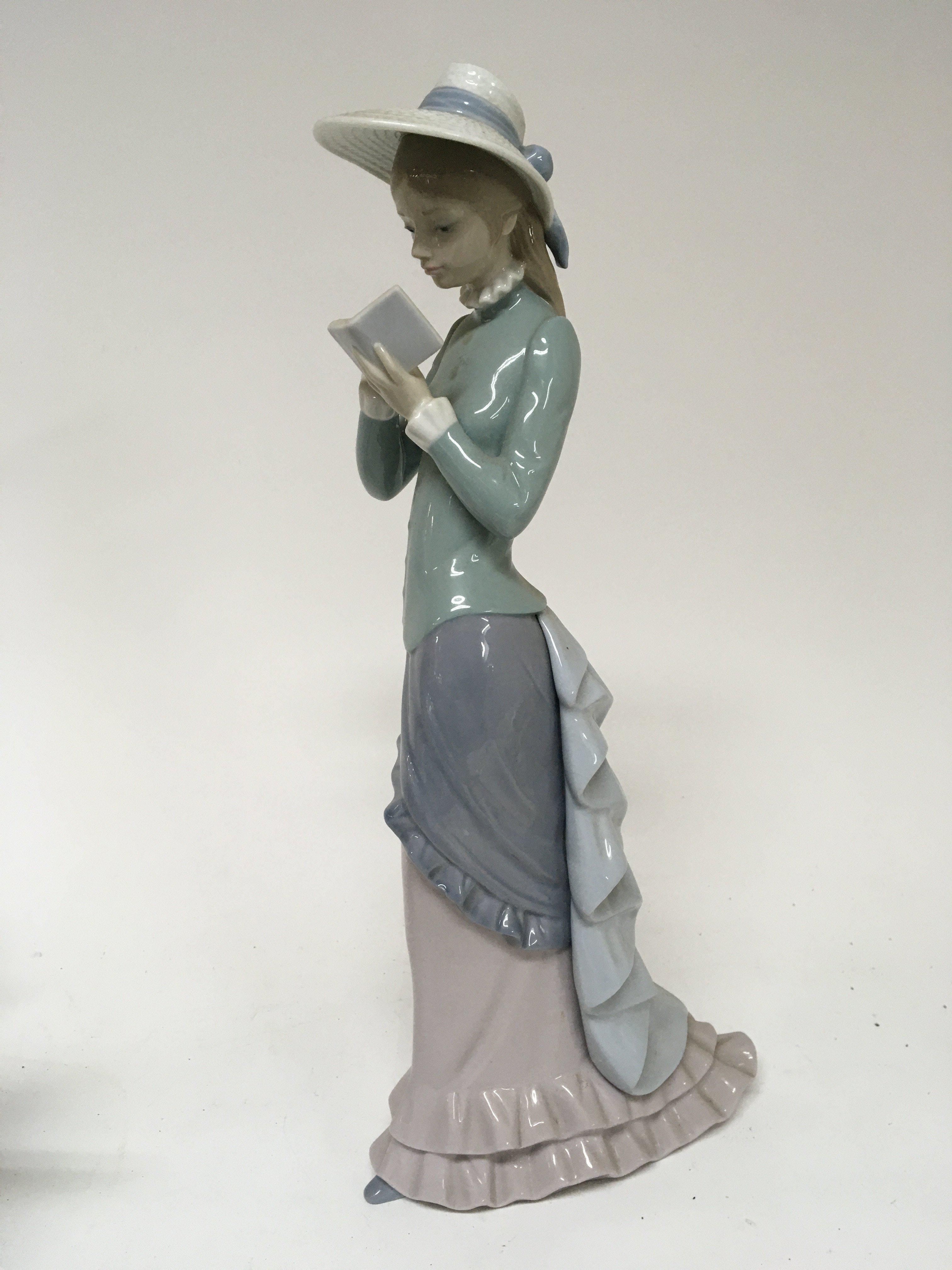 A large Lladro figure of a young lady in full leng