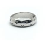 An 18ct white gold ring with eight small diamonds,