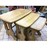 A nest of three light blonde Ercol Elm occasional