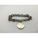 A silver Tiffany bracelet.