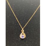 A 9ct gold diamond and tanzanite pendant on a 9ct