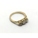 An 18ct gold ring set with three old cut diamonds,