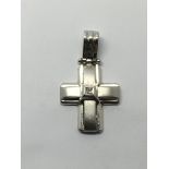 An 18ct white gold cross set with a small diamond,