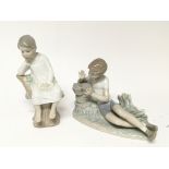 Two Lladro figures a young boy with a small bird a
