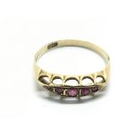 An 18ct gold ring set with rubies, approx 1.9g and