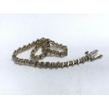 A 14ct gold and diamond tennis bracelet. 18.5cm.