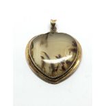 A 9ct gold pendant set with a polished agate stone