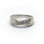 An 18ct white gold crossover ring with seven diamo