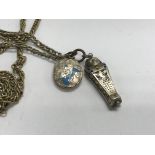 A silver and enamel pendant in the form of a mummy