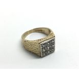 A 9ct gold ring set with nine CZ stones, approx 7.