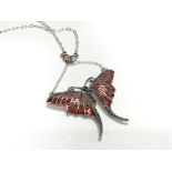 A large silver butterfly necklace set with cabocho