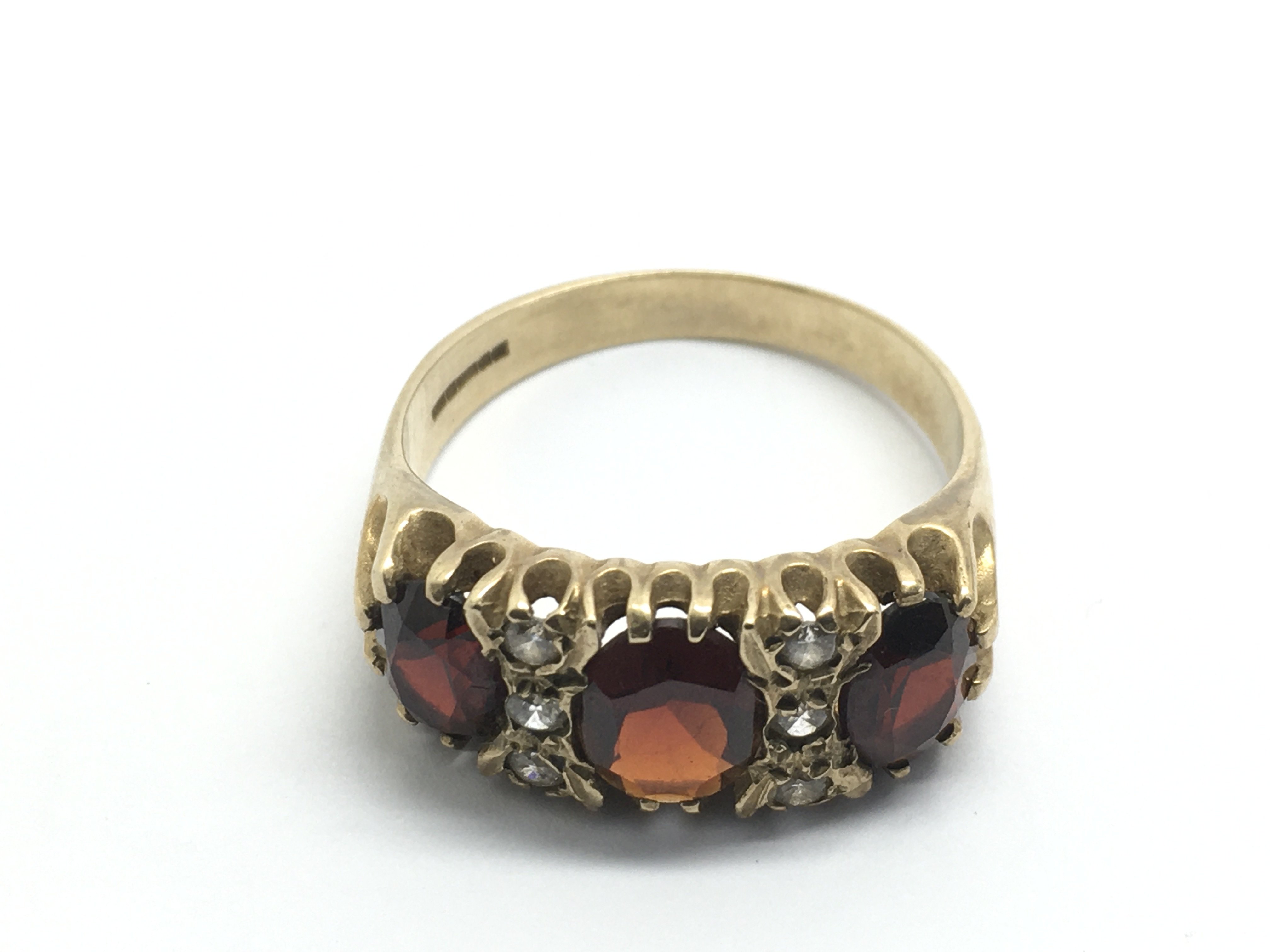 A 9ct gold ring set with garnets and small diamond