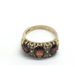 A 9ct gold ring set with garnets and small diamond