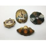 Four brooches, one set with a hand painted porcela
