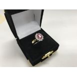 A 9ct gold ruby and diamond cluster ring.