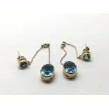 A pair of 9ct gold blue topaz and diamond drop ear
