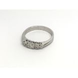 A 9carat white gold ring set with a row of brillia