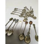 A collection of Chinese white metal tea spoons sil