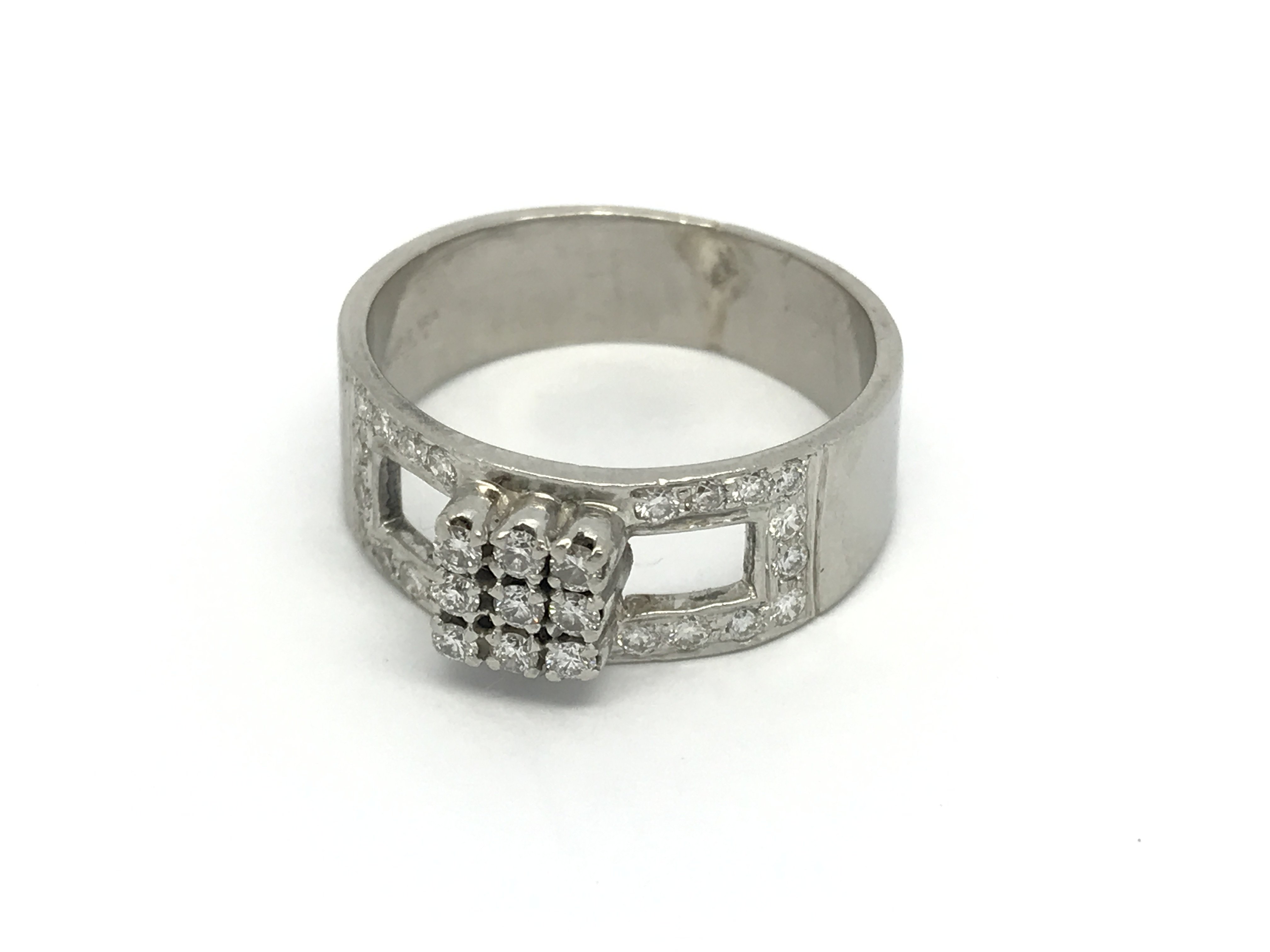 An 18carat white gold ring set with a buckle type