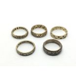 A collection of worn gold and silver eternity ring