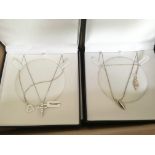 A collection of 12 silver pendants and chains.