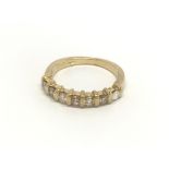 An 18carat gold ring set with a a subdivided row o