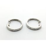 A pair of 9ct white gold half eternity hoop earrin