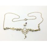 A gold necklace set with pearls and one loose natu