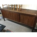 A modern Danish type teak sideboard with three sli